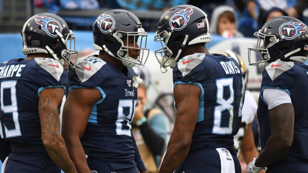 Tennessee Titans tight end Jonnu Smith (81) celebrates with Tennessee Titans wide receiver Corey Davis (84) after a touchdown reception during the first half against the New Orleans Saints at Nissan Stadium.